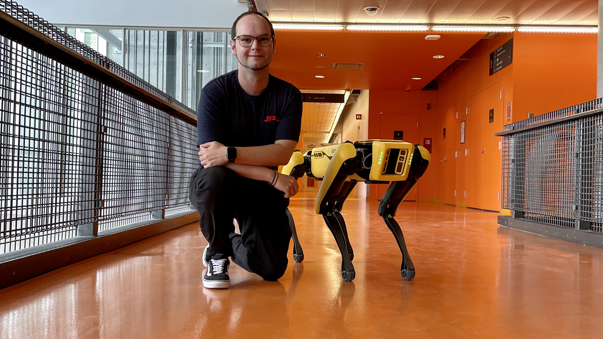 Marcel Kaufmann kneels next to a so-called Mars Dog